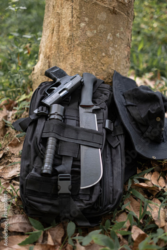 machete knife and a hiking backpack rest on a log.