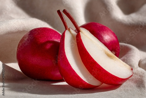 Red anjou pears whole and sliced on linen