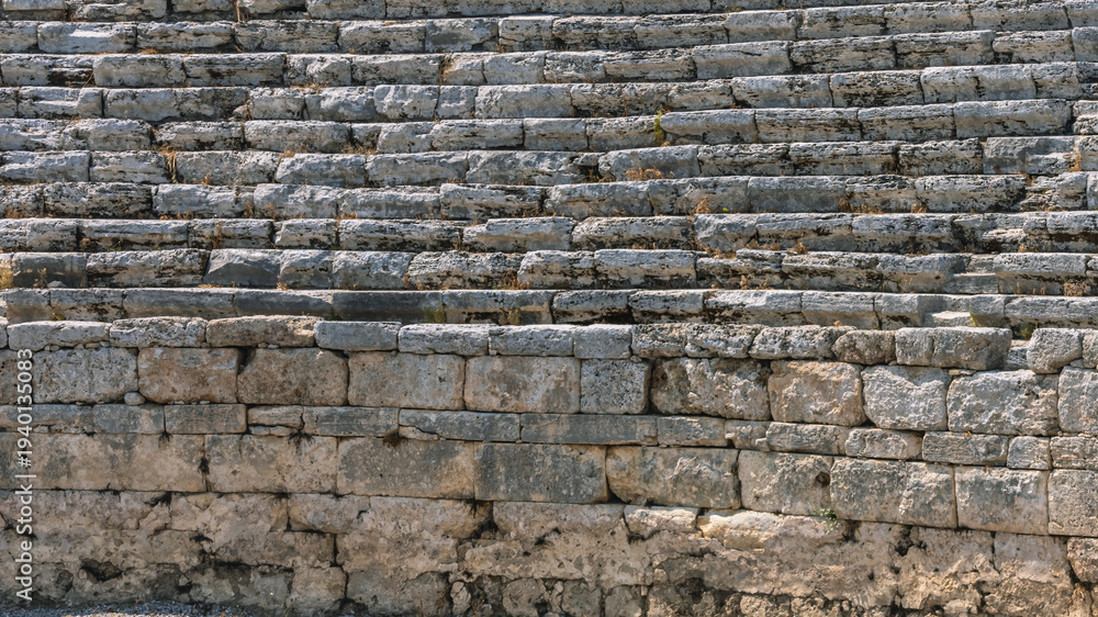 Naklejka premium The stadium is located in the ancient city of Perge in Turkey. An ancient city founded during the Trojan War. Ruins of an ancient stadium. The stands are made of hewn stone blocks.