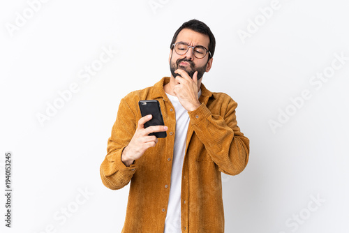 Caucasian handsome man with beard wearing a corduroy jacket over isolated white background thinking and sending a message