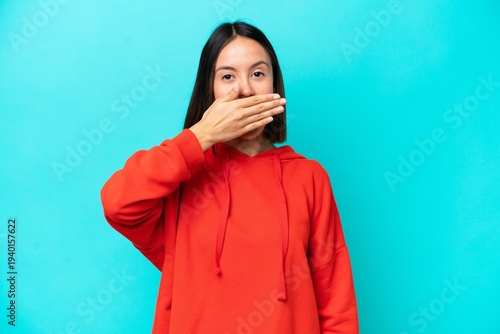 Young caucasian woman isolated on blue background frustrated and covering ears