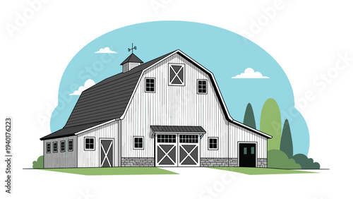 Classic white farmhouse barn with a gray roof and weather vane standing in a rural landscape with green trees and blue sky.
