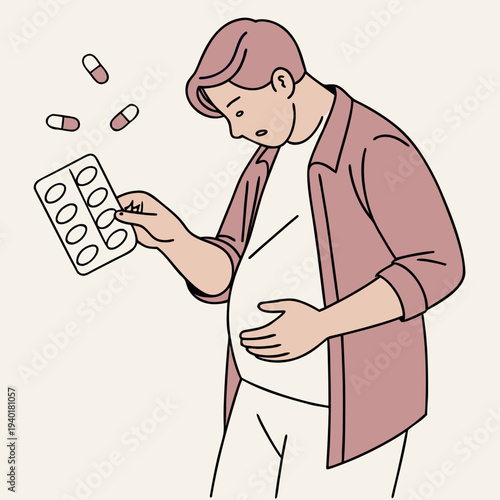 Man with stomach pain looking at medicine pills.