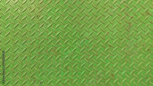 Green painted diamond plate metal texture with industrial non-slip pattern