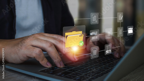 Document Management System (DMS),Businessman using a laptop searching folder and managing files paperwork.Software for archiving,share online database server, administration employee in enterprise.