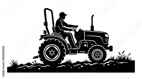 Man driving tractor through field with large tires and grassy terrain
