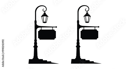 Two antique street lamps with blank signs a striking silhouette
