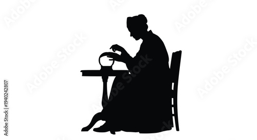 Woman seated at table gazing into crystal ball dramatic silhouette