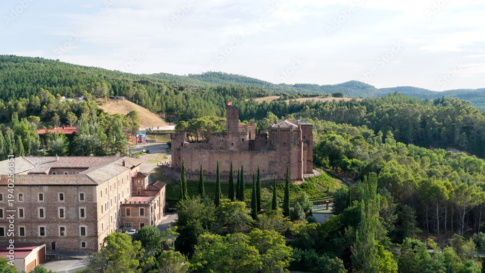Obraz premium Javier Castle, a medieval fortress, showing historic architecture and stone walls surrounded by lush green forests in Navarre, Spain