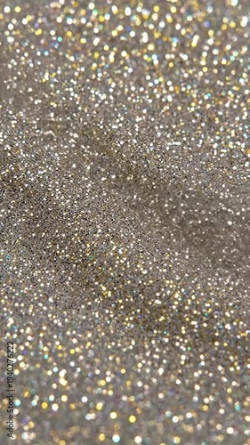 Gritty Silver Dance Raw, high-contrast silver and grey glitter with pronounced fine grain, exhibiting a subtle, almost vibrating movement, emphasizing its metallic and 'noisy' texture in extreme