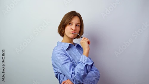 Beautiful young girl smiling holding glasses for vision thinking about purchase happy woman with eyeglasses considering buying new frames studio portrait optics
