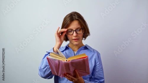 Girl with poor vision putting on glasses reading book young woman with bad eyesight wearing eyeglasses to read education learning solving vision problem studio