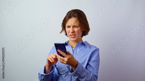 Girl with headache eye strain from glasses and mobile phone young woman with tension from screen digital eye fatigue stress technology overuse studio