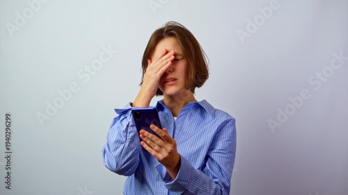 Girl with headache eye strain tired stressed from screen and social media phone young woman with digital fatigue technology overuse mental exhaustion studio