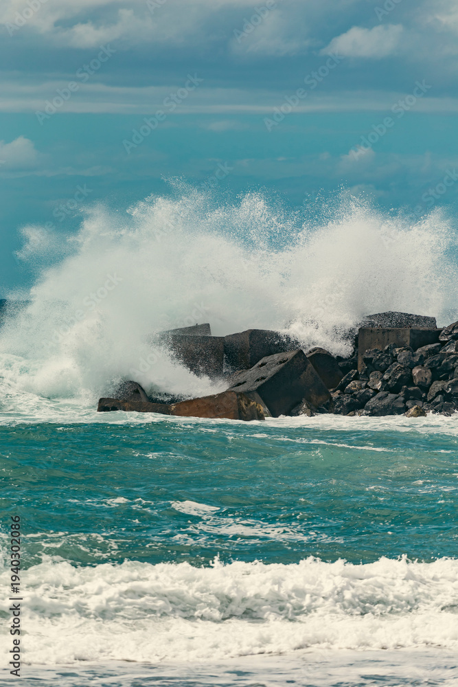 Fototapeta premium Massive Powerful Atlantic Ocean Wave Crashing Over Concrete Barrier with copy space