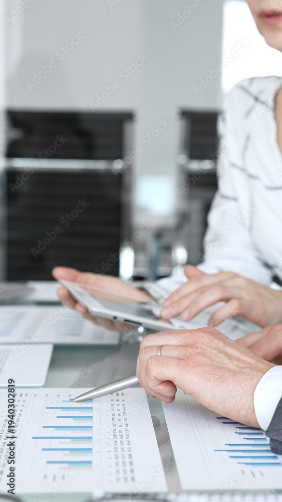 Fototapeta premium Business person's hands holding a pen, reviewing and signing a legal contract or agreement document during an important office meeting, finalizing a deal