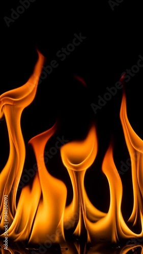 Close-up of vibrant orange flames dancing and flickering against a stark black background.