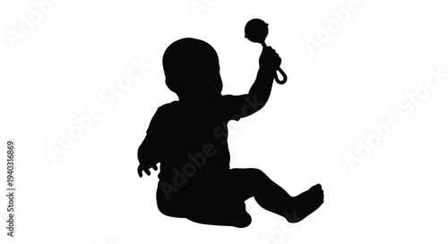 Baby reaching for a rattle depicted in dark dramatic silhouette