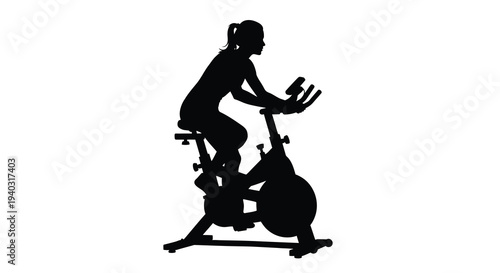 Woman intensely cycling on an exercise bike black silhouette