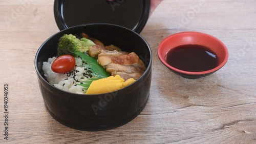 grilled chicken dressing Teriyaki Japanese sauce on rice with sweet egg and vegetable depping black sweet soy sauce bento set in lunchbox