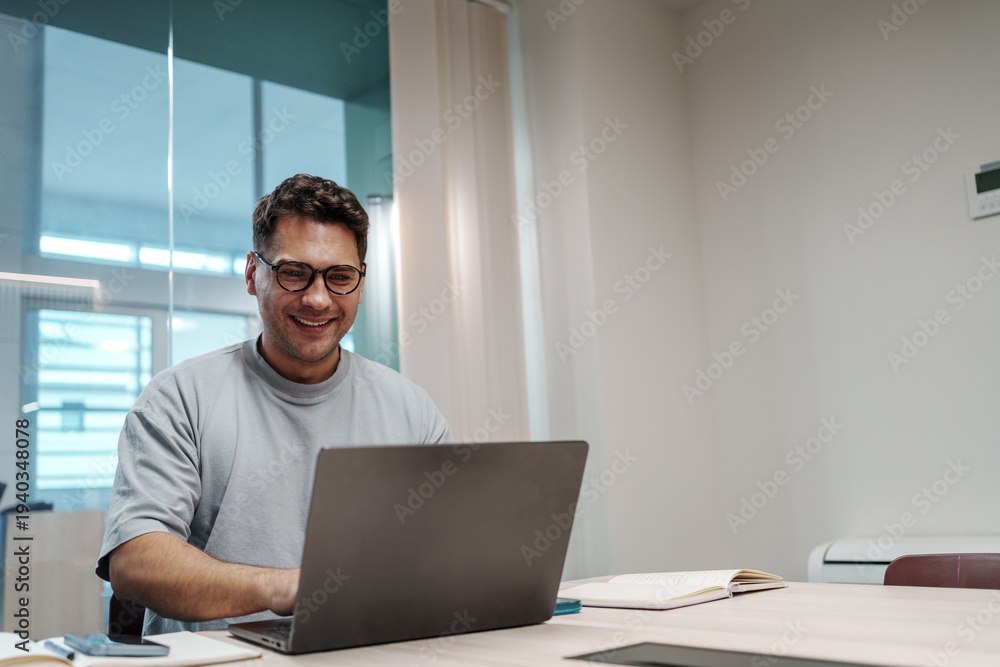 Fototapeta premium Man Coding Happily. White Male Software Engineer Concluding Productive Day With Contented Look