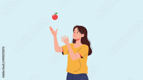 Young woman with long hair wearing a yellow shirt and blue jeans tossing a fresh red apple into the air against a plain light background.