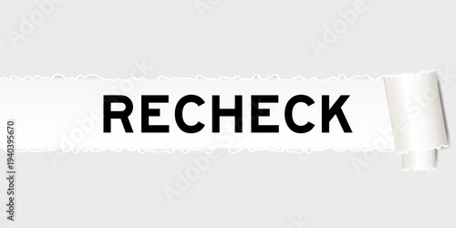 Ripped gray paper background that have word recheck under torn part