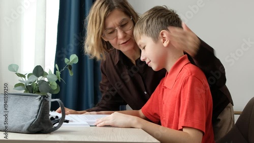 Boy Doing Homework with Loving Mother at Home