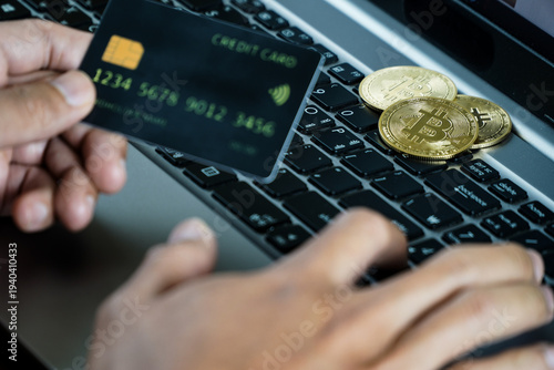 Persons Hands Engaging in Digital Cryptocurrency Trading on Laptop with Bitcoin Coins