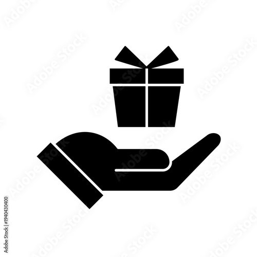 Vector art illustration of a hand holding a neatly wrapped gift box with a red bow on top. Hand gift con vector silhouette on white background. Silhouette of a hand holding a gift box with ribbon.