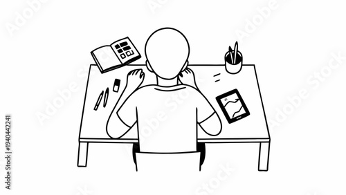 A person sits at a desk working on creative projects with a sketchbook and digital tablet