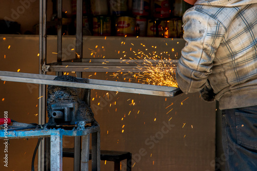 Obraz na płótnie Metalworker Grinding Steel with Bright Sparks