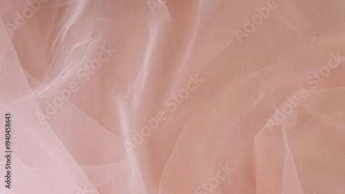 Nylon Fabric with Soft Folds Moving Across a Beige Background, Texture and Softness of the Material