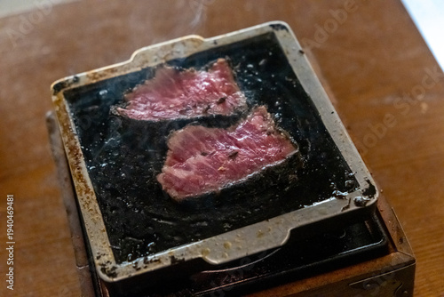 Black Gyukatsu or beef cutlet. A traditional Japanese food that consists of a deep-fried beef cutlet. on the grill