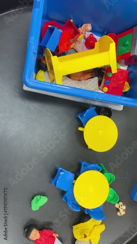 Wallpaper Mural Bright multicolored plastic construction blocks are arranged in a kindergarten classroom. Pieces on a table indoors. Educational play materials used in early childhood settings. Vertical video Torontodigital.ca