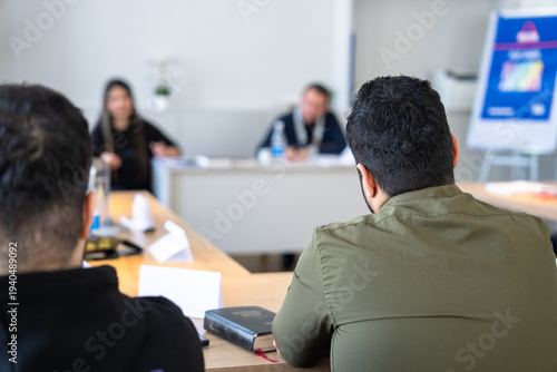 Group Bible study session with open scriptures on table, people reading and discussing faith, spirituality, and religious learning together in a peaceful indoor environment.