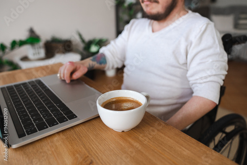 Wallpaper Mural Amputee disabled person on the wheelchair with laptop and coffee Torontodigital.ca