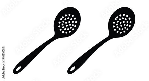 Two black slotted spoons displayed against a white background silhouette