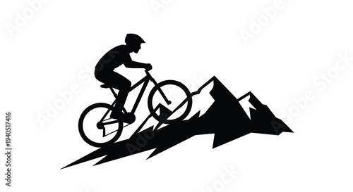 Mountain biker rides uphill against a jagged landscape silhouette