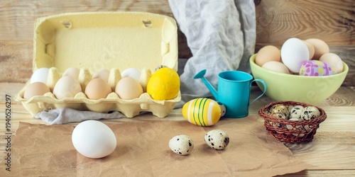 Easter, preparation for the holiday. Various colored and fresh chicken and quail eggs on a rustic wooden table.