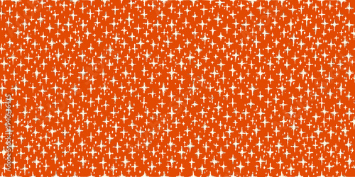 Bright orange background covered in small scattered white star shapes