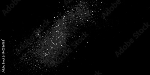 Abstract explosion of white particles against a dark black background
