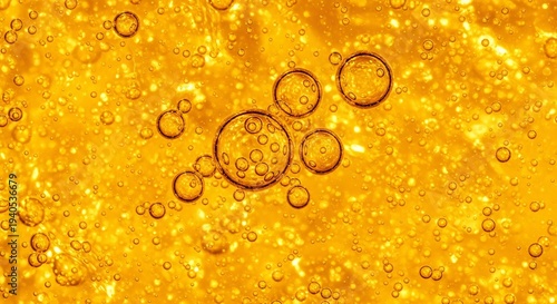 Vibrant amber texture background, macro detail of glowing golden essential oil or vitamin c serum droplets.