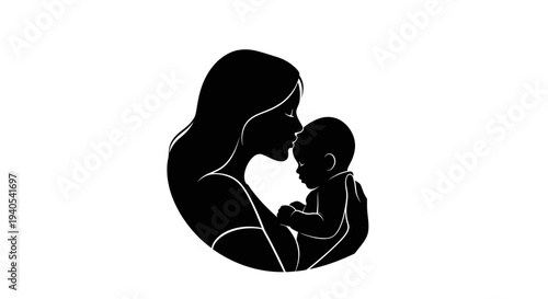 Mother holding and kissing her newborn baby tenderly.