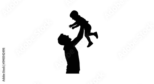 Silhouette of a man tossing a child in the air.