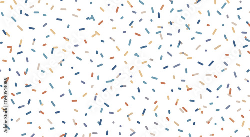 Abstract confetti pattern made of short colorful dashes in blue brown and tan shades scattered randomly across a bright white background space.