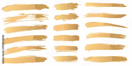 Assorted golden brush strokes arranged on a plain white background