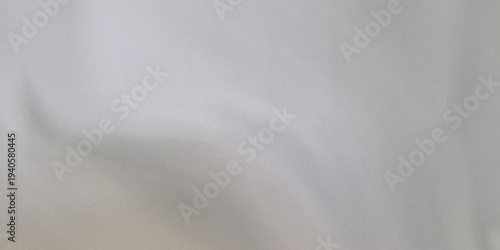 Light grey textured fabric or surface with soft shadows