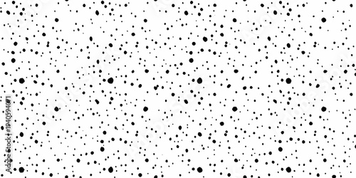 Abstract black spots scattered across a bright white background texture