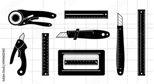 Various office cutting tools and rulers on a grid background for organization and precision